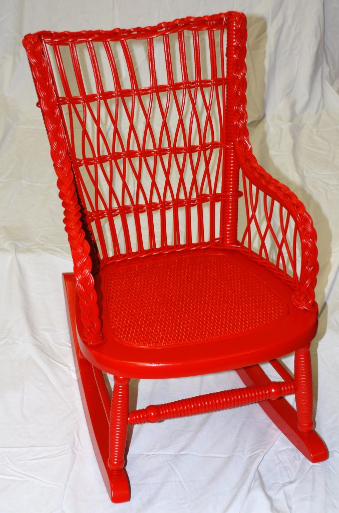 Child's wicker chair painted bright red after we restored it